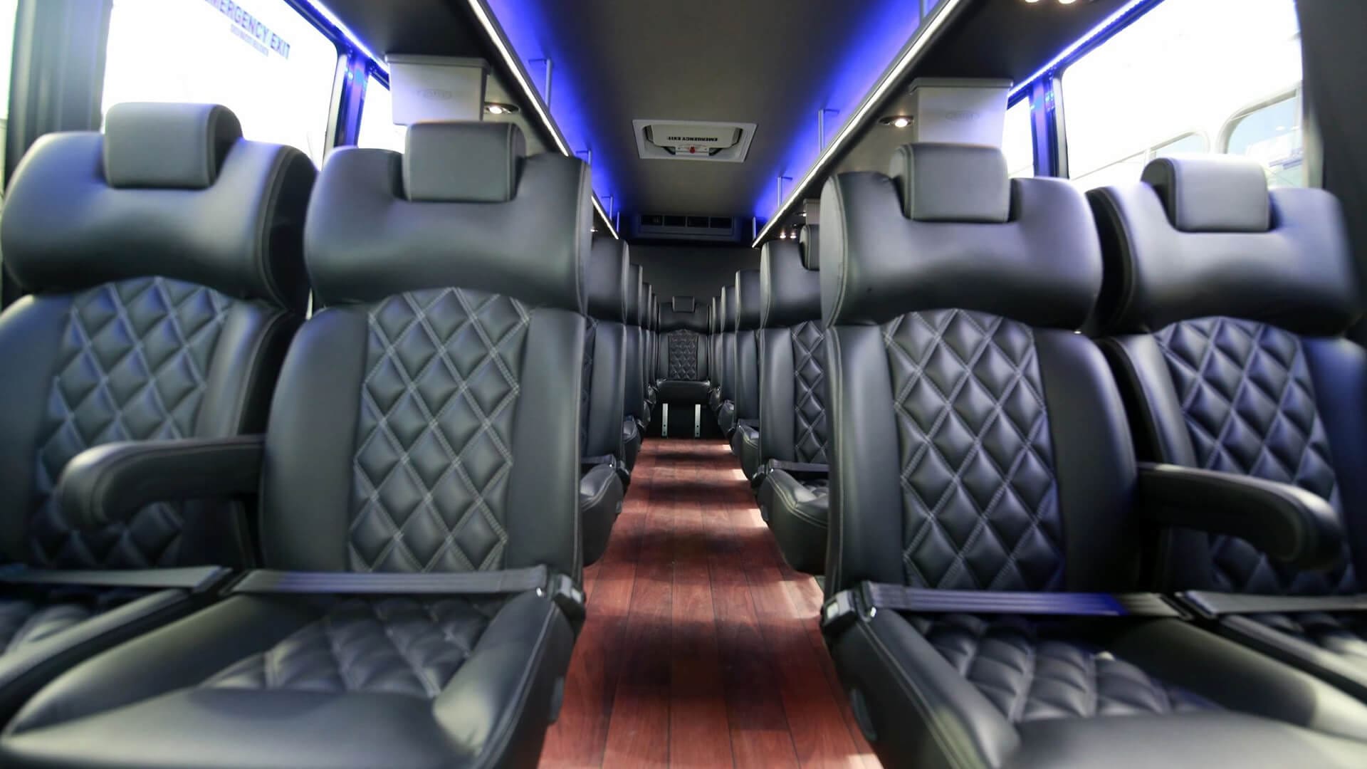 A bus with black seats and blue lights