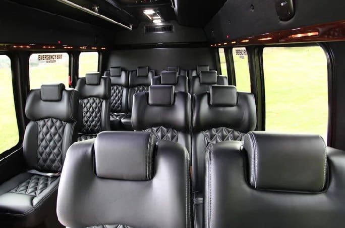 A black bus with many seats in it