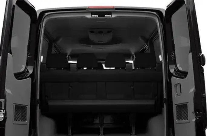 A van with the back door open and rear seats down.