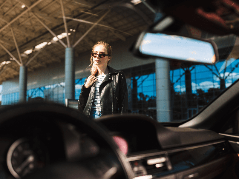 Young woman departing airport terminal